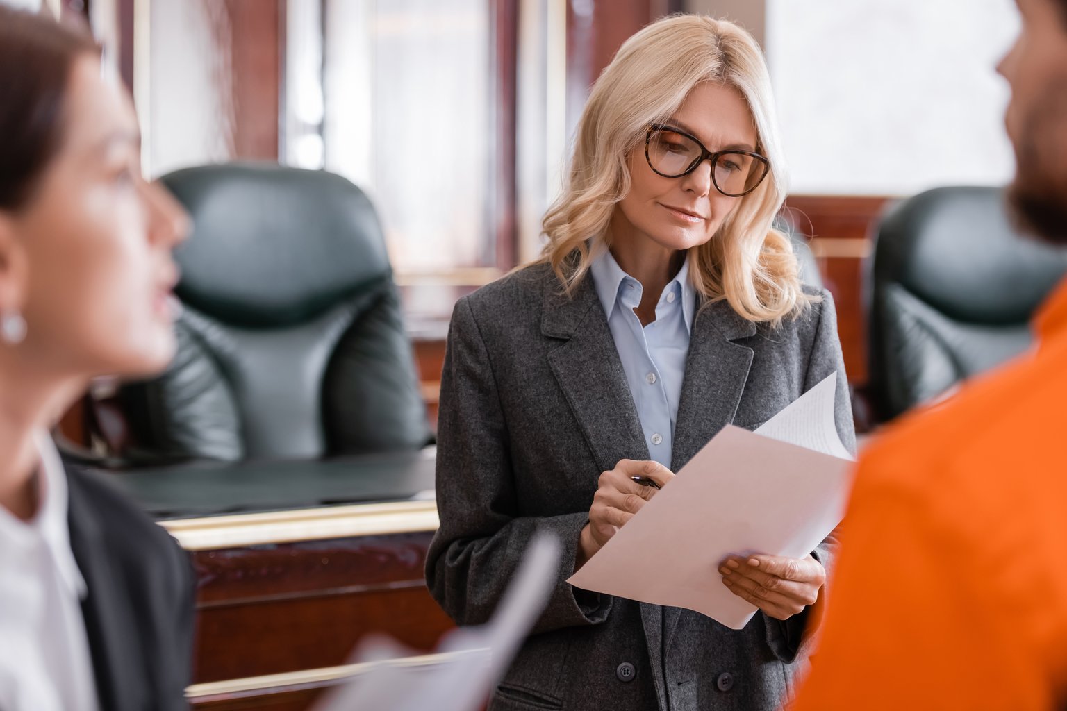 Probation officer reviewing case documents in a courtroom